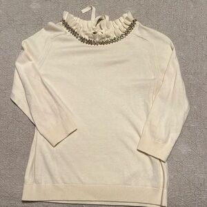 Cream sweater with jeweled neckline. SP
